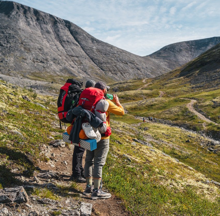 People traveling through mountains in background